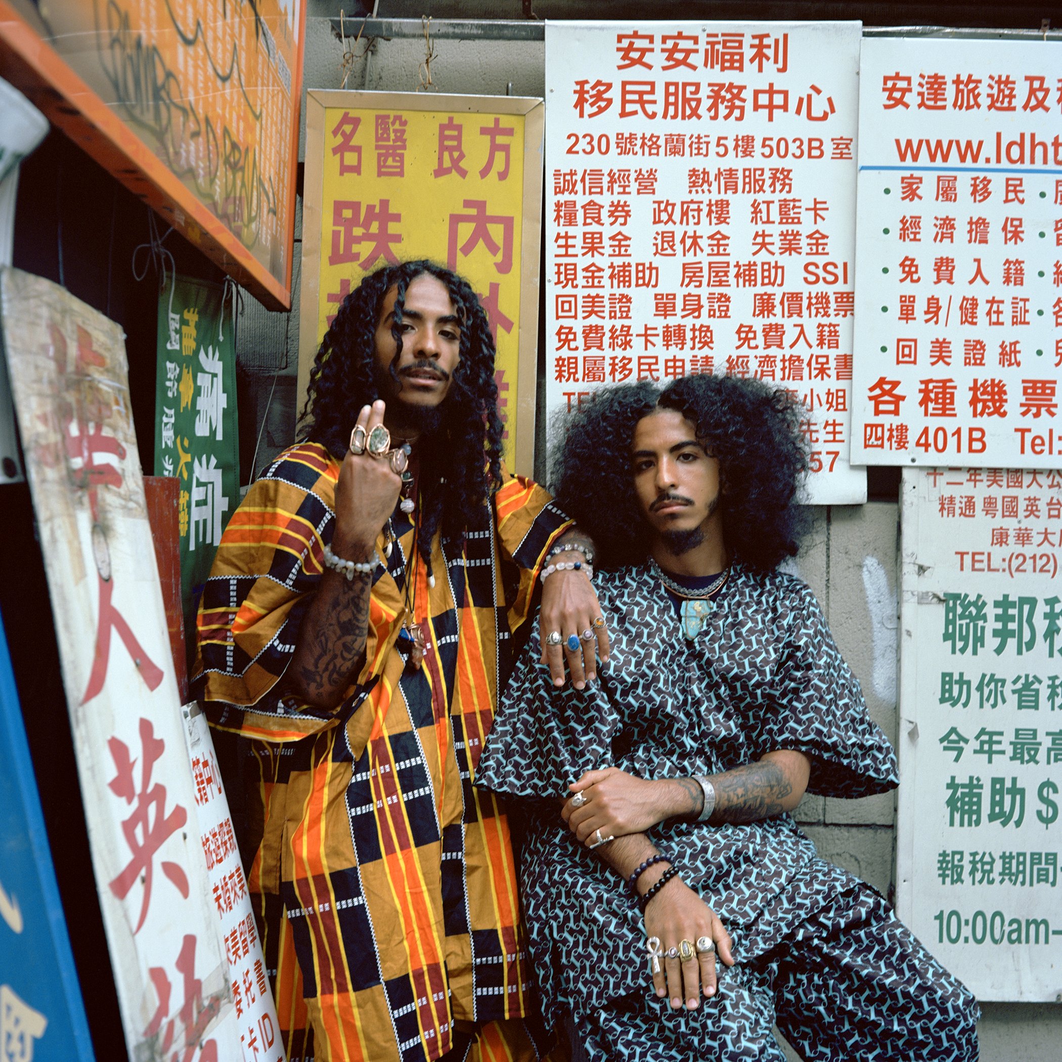 Photo of two twins standing in front of market signs from NFT photography collection, Twin Flames