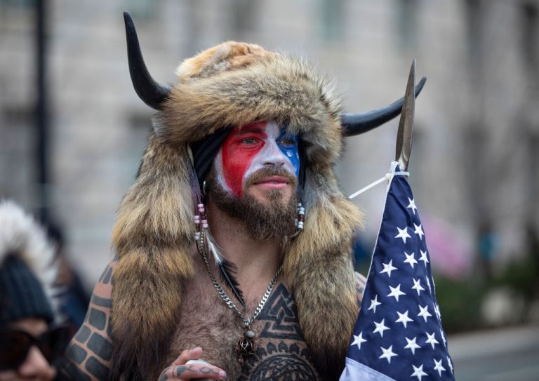 Jacob Chansley at the insurrection wearing the American flag and a Viking hat