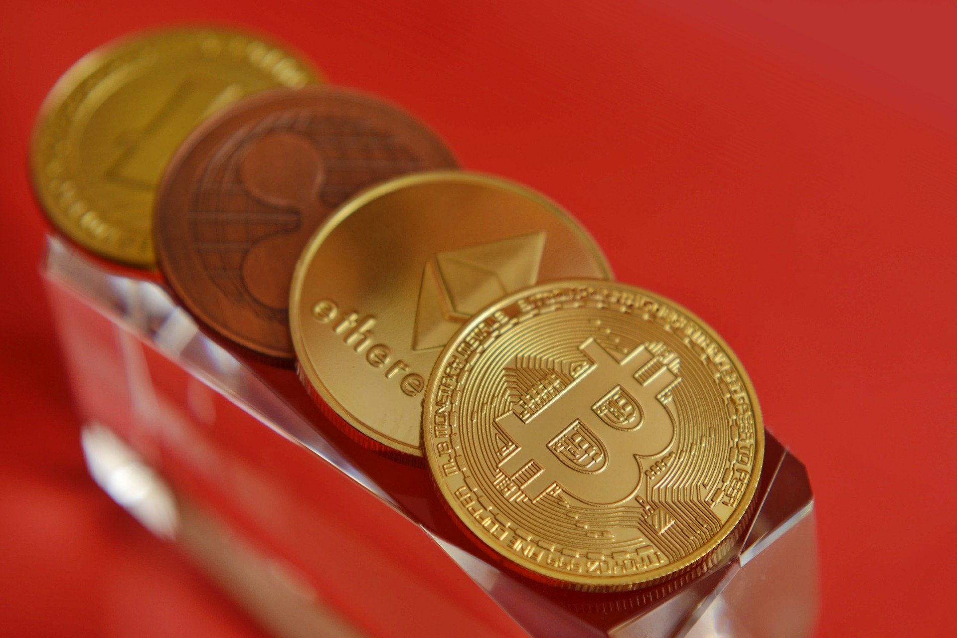 Photograph of golden coins with cryptocurrencies on them