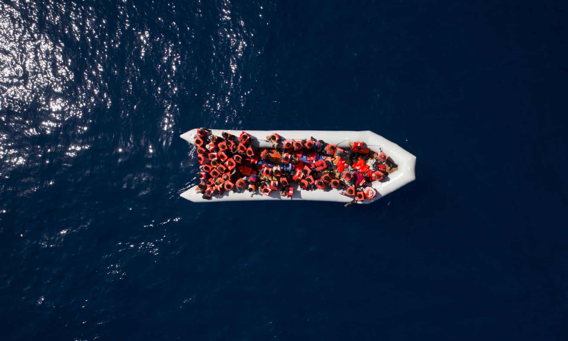 photo of an overcrowded rubber boat north of the Libyan coast as an NFT